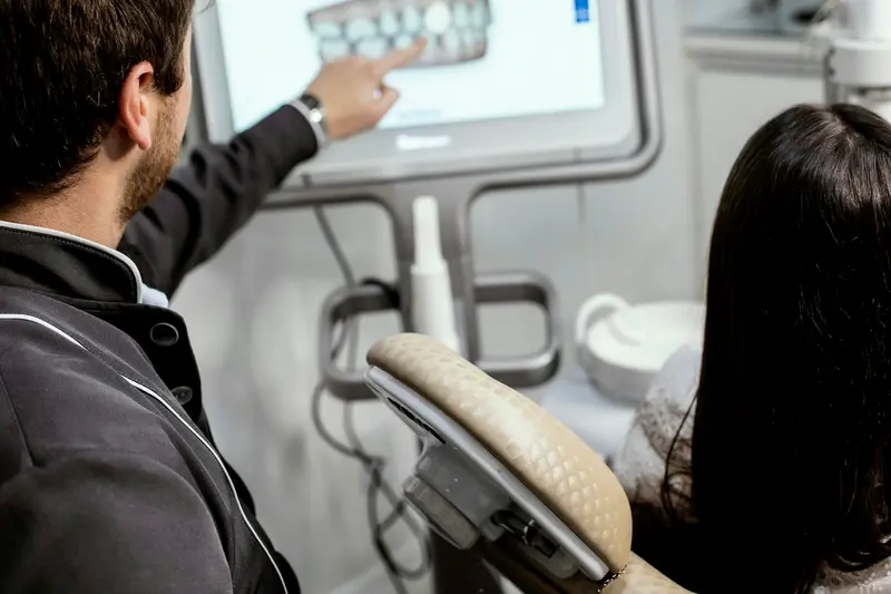 Dentist walking a patient through a digital scan of her teeth