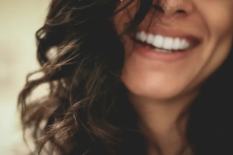 Woman laughing with a bright, natural smile