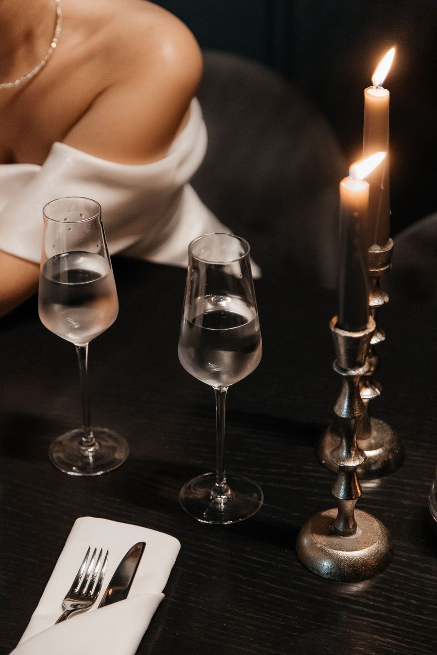 Candlelit place setting with crystal glasses