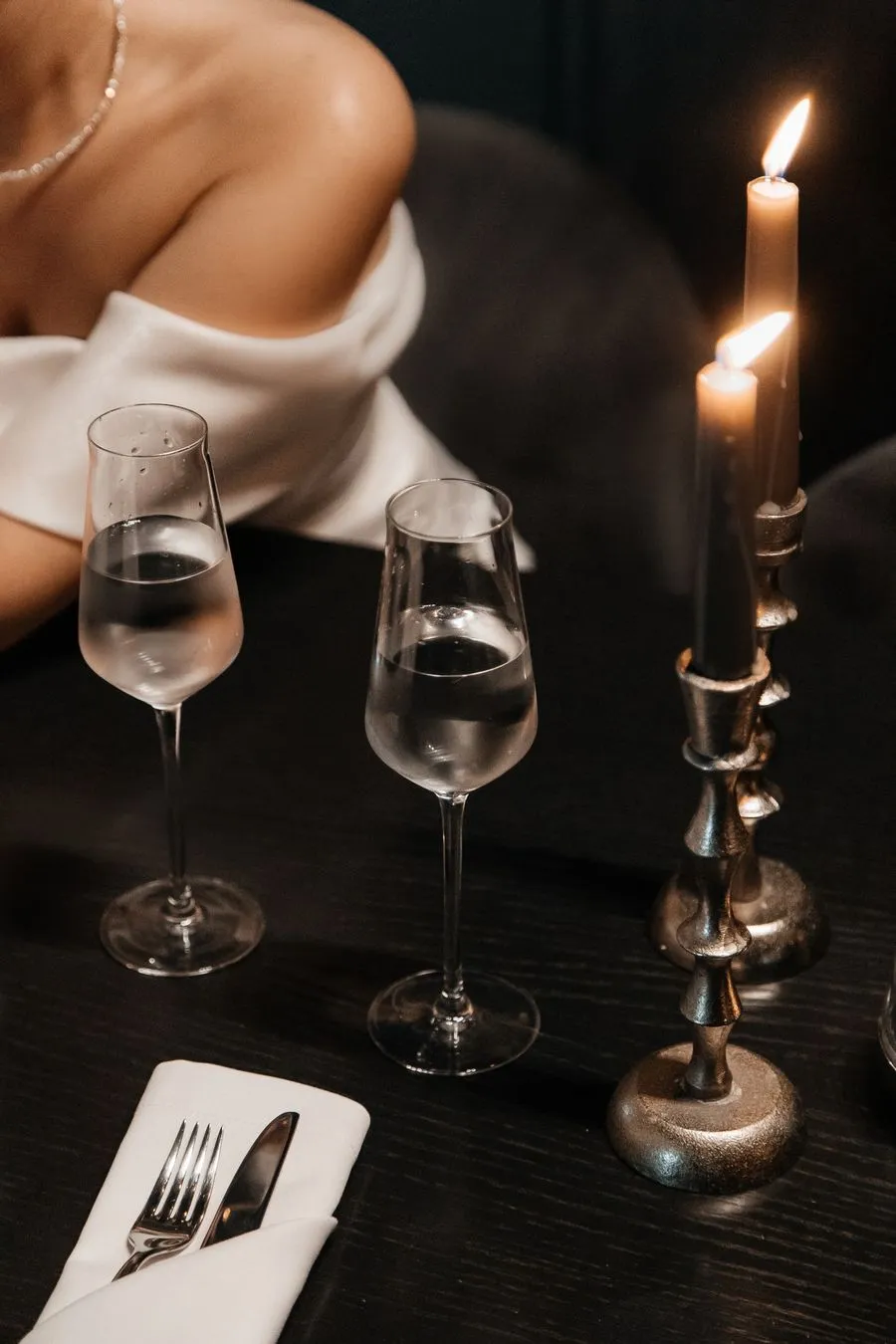 Candlelit place setting with crystal glasses