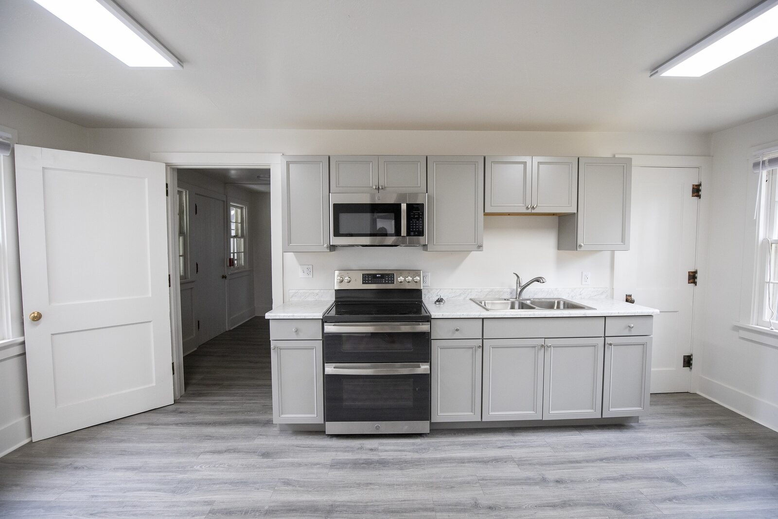 The new range wall with shaker cabinets and a stainless range
