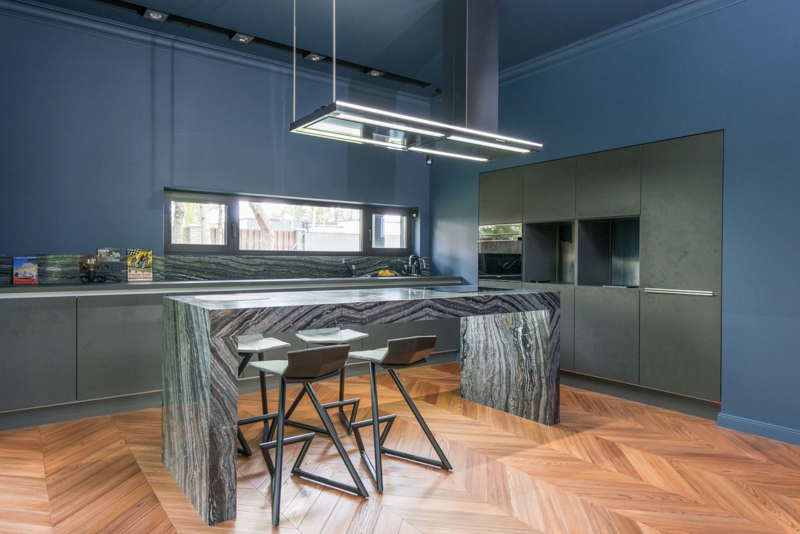 Remodeled kitchen with blue cabinetry and a granite island