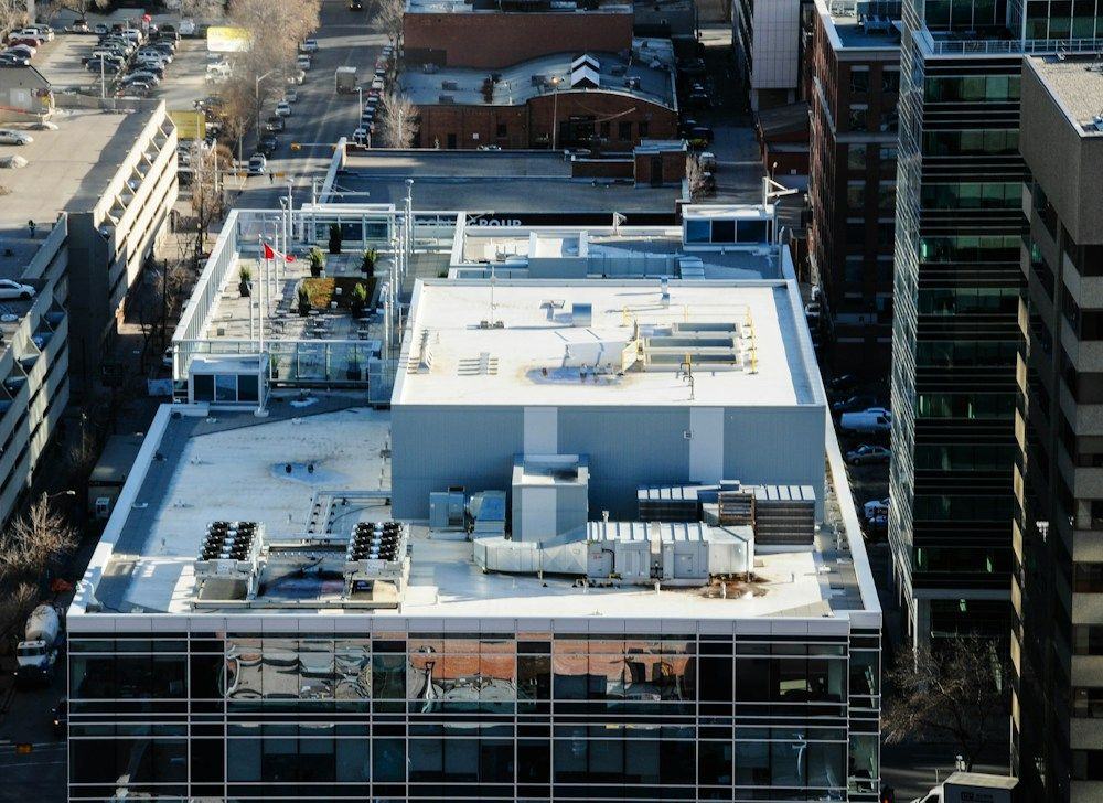 White single-ply membrane flat roof with rooftop HVAC units