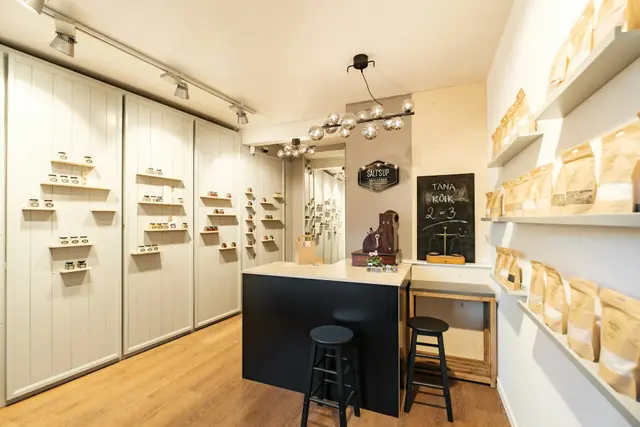 Bright optical boutique with eyeglass frames displayed on white shelves