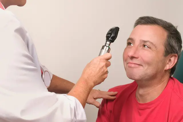 Doctor examining a patient's eye with an ophthalmoscope